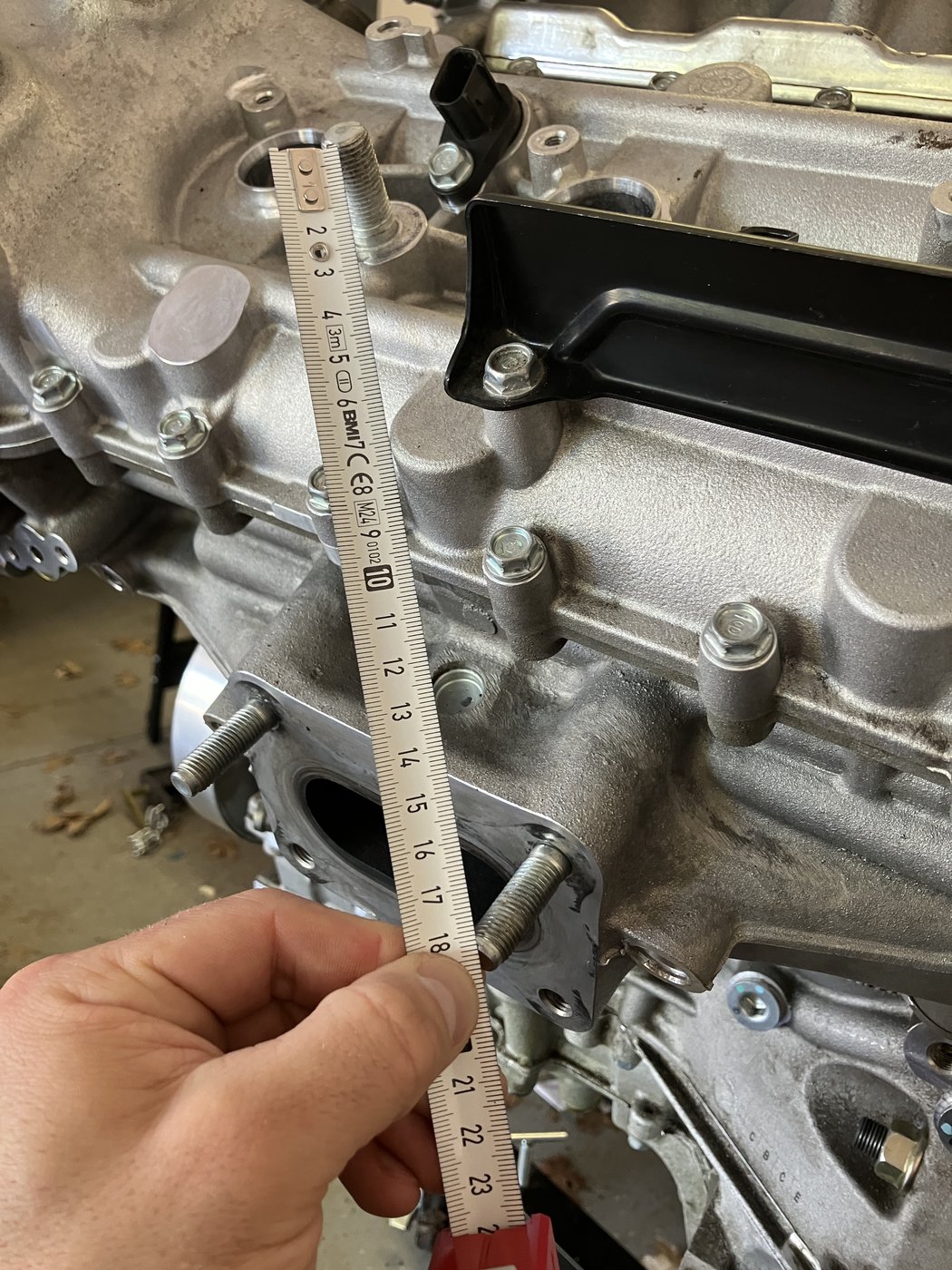 Measuring an NSX engine assembly with a tape measure during a component packaging study